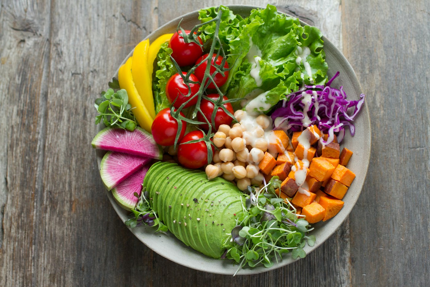 A colorful salad bowl with fresh vegetables and greens